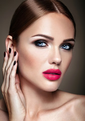 Fototapeta premium Portrait of beautiful girl model with evening makeup and romantic hairstyle touching her skin. Pink lips
