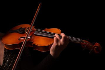 Hands of musician playing the violin isolated on black