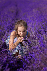 girl in a dress sits in lavender