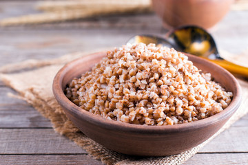 Buckwheat porridge in a bowl on a wooden table