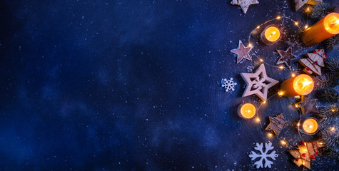 Christmas background with wooden decorations and candles. Free space for text