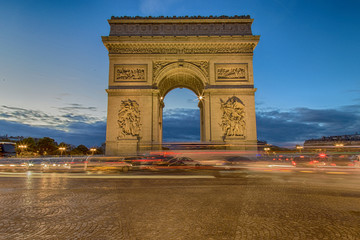 Fototapeta na wymiar View of arc de triomphe during the twilight and long exposure image with light trails