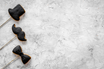 Men birthday concept. Set of cookies in shape of black tie, mustache and hat. Grey stone background...
