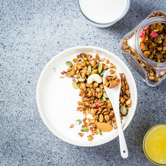 Honey cococnut granola yogurt bowl on dark concrete background. Top view, space for text.