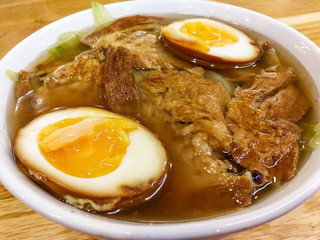 Bowls of Asian soup noodles and vegetables