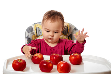 Fototapeta premium Cute child with red apples isolated on white background