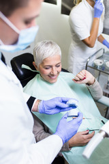 Beautiful senior woman receiving a dental treatment. Close up shot.
