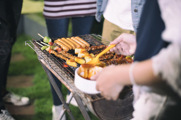 Asian group of Friends making barbecue and grilled shashliks on grate party in outdoor garden