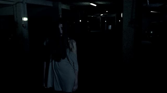 Scary female zombie in garage ready to attack and kill