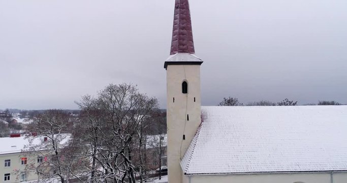 Aerial view of old church afer snowfall. Cross close up.