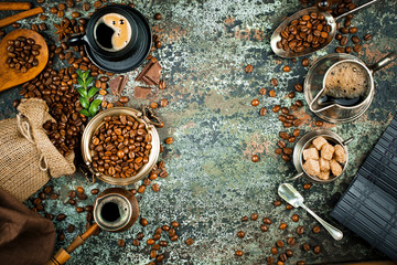 Fototapeta na wymiar Black coffee in a cup on the background of coffee beans in a composition with accessories