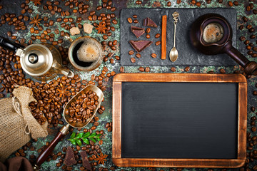 Black coffee in a cup on the background of coffee beans in a composition with accessories