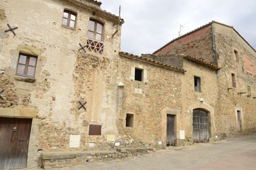 Fototapeta na wymiar Old stone houses in Monells, Girona, Spain