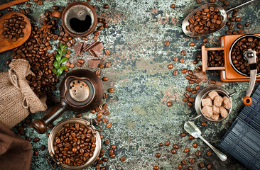 Black coffee in a cup on the table in a composition with coffee accessories on an old background