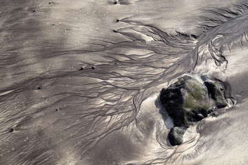 Volcanic sand shapes on the Canary island Tenerife beach, after ebb tide (low tide). 