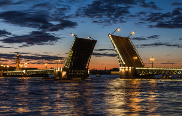 Fototapeta na wymiar Palace Bridge (1912-1916), a road- and foot-traffic bascule bridge, spans the Neva River between Palace Square and Vasilievsky Island. White nights in Saint Petersburg, Russia