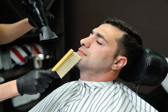 After Shaving Beard, Hairdresser Is Removed Hair From The Face With A Brush