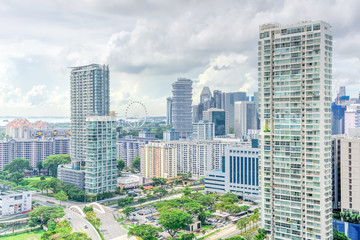 Public residential condominium building complex and downtown skylines at Kallang neighborhood in Singapore. Storm cloud sky.
