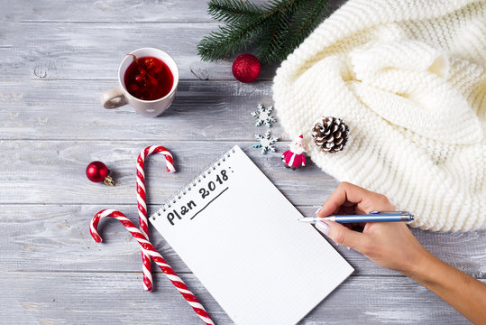 Hand of woman writing Christmas greetings