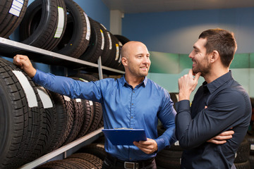 customer and salesman at car service or auto store