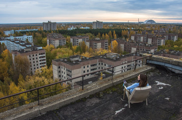 Girl seattingin Pripyat Chernobyl Zone, autumn time Chernobyl, Ukraine