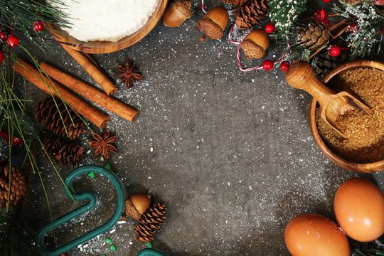Christmas baking Ingredients  -eggs,flour,cutters,flour and spices on festive holiday background
