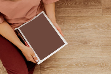 Young woman with a booklet with blank pages