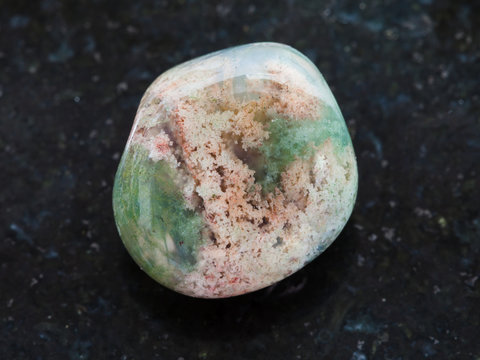 tumbled Moss Agate gemstone on dark