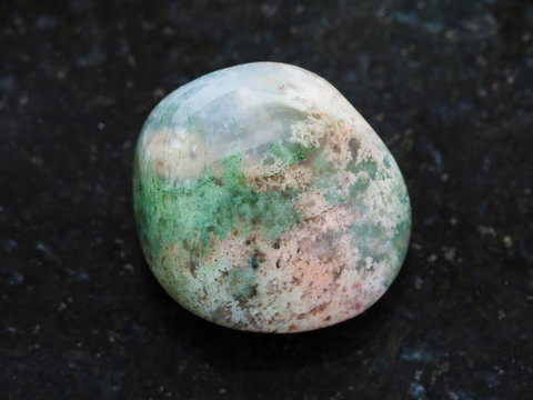 polished Moss Agate gemstone on dark