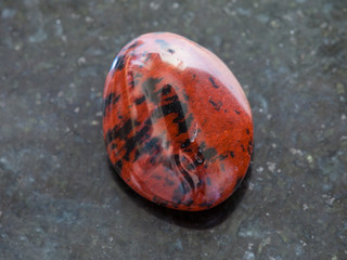 polished mahogany obsidian gemstone on dark