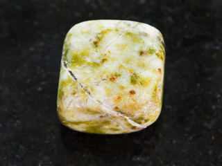 tumbled agate gem stone on dark background