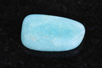 tumbled Aquamarine (blue beryl) gemstone on dark