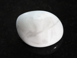 tumbled magnesite gemstone on dark background