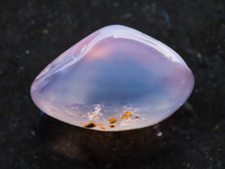 polished chalcedony gemstone on dark background