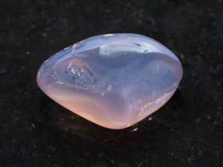 tumbled translucent moonstone gemstone on dark