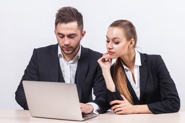 Picture of couple of office workers working together on PC
