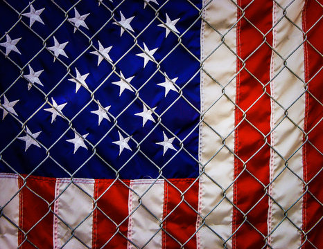 American flag behind chain link fence