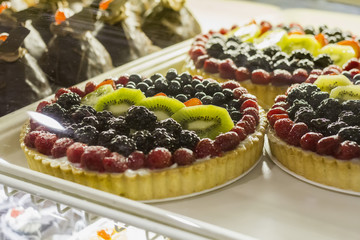 Fresh Sweet Cake With Currant And Strawberry Berries On Top In Pastry Shop Glass Display