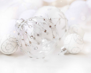 Fototapeta na wymiar Festive glass Christmas ball with silver glitter and crystals, beautiful Christmas decorations and ornaments