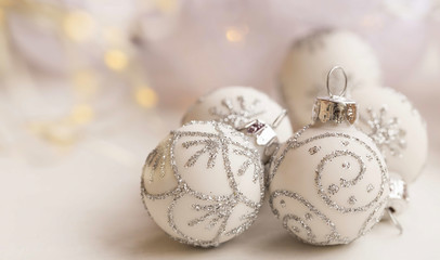White Christmas balls with silver glitter closeup, winter holidays and Christmas greeting concept