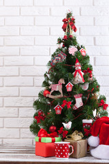 White wooden table in front of colorful christmas tree with gift boxes. Can be used for display or montage your products