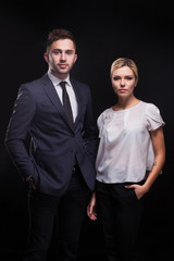 Picture of young couple of office workers standing