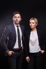 Picture of young couple of office workers standing