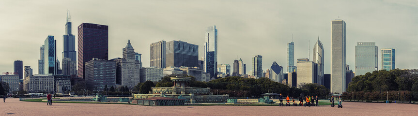 Buckingham Fountain, Millennium Park, Chicago Downtown. Tourists on segways. Cloudy day. High resolution panorama.
