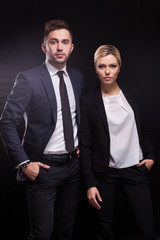 Picture of young couple of office workers standing