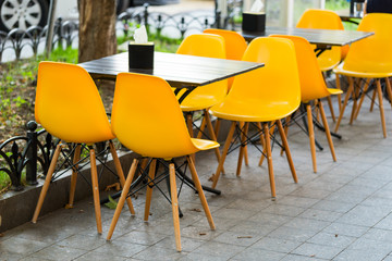 chairs and tables on the street in a cafe