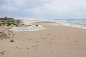 Empty sandy sea coast seaview, cloudy colourful sunrise skyview
