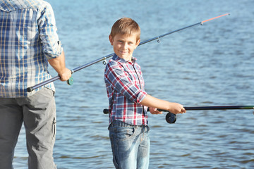 Little boy fishing on pond