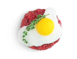 Delicious steak tartare with egg on white background