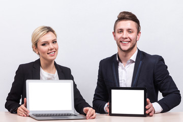 Picture of team of office workers both holding tablet